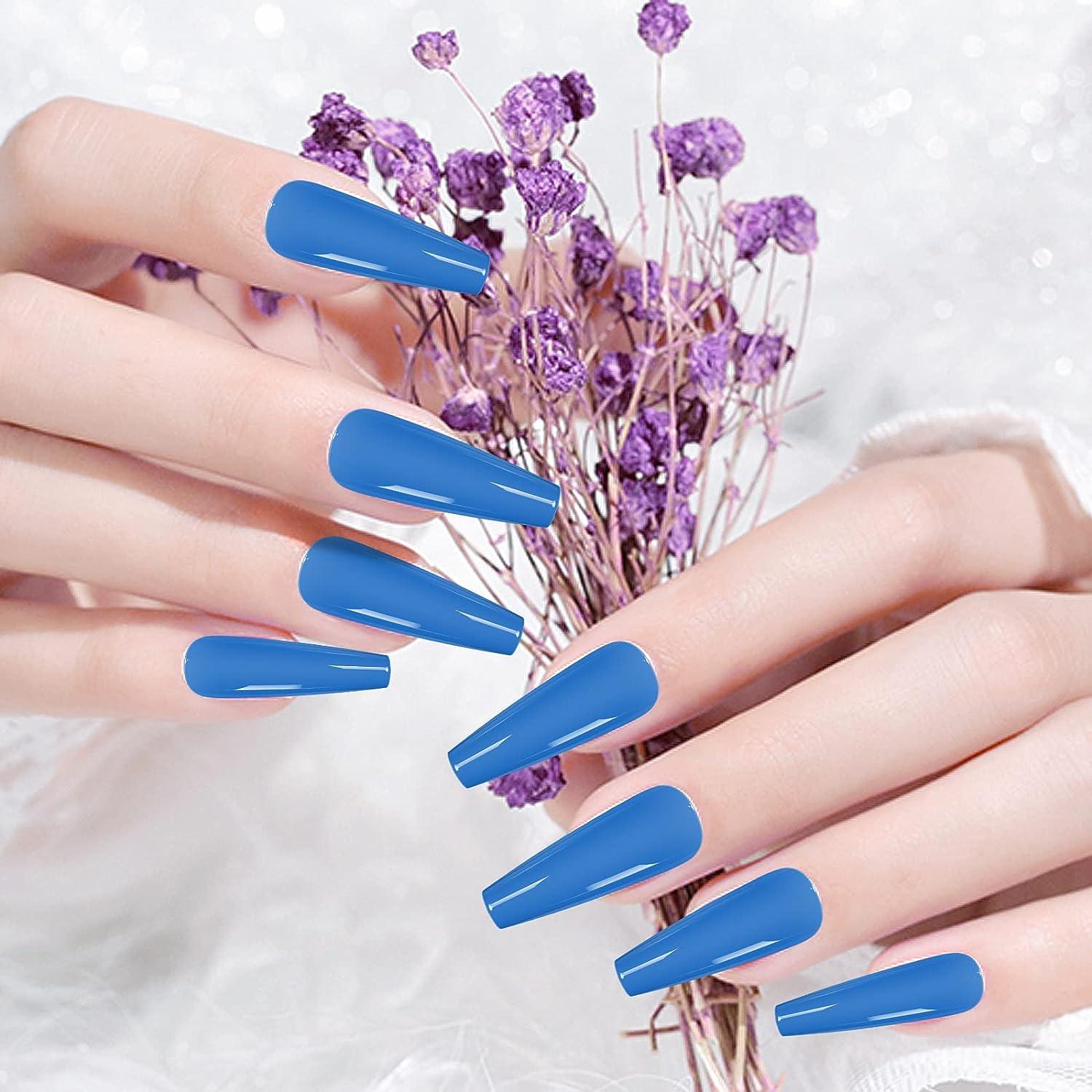 Female hand with long nails and light blue manicure with bottles of nail  polish Stock Photo - Alamy