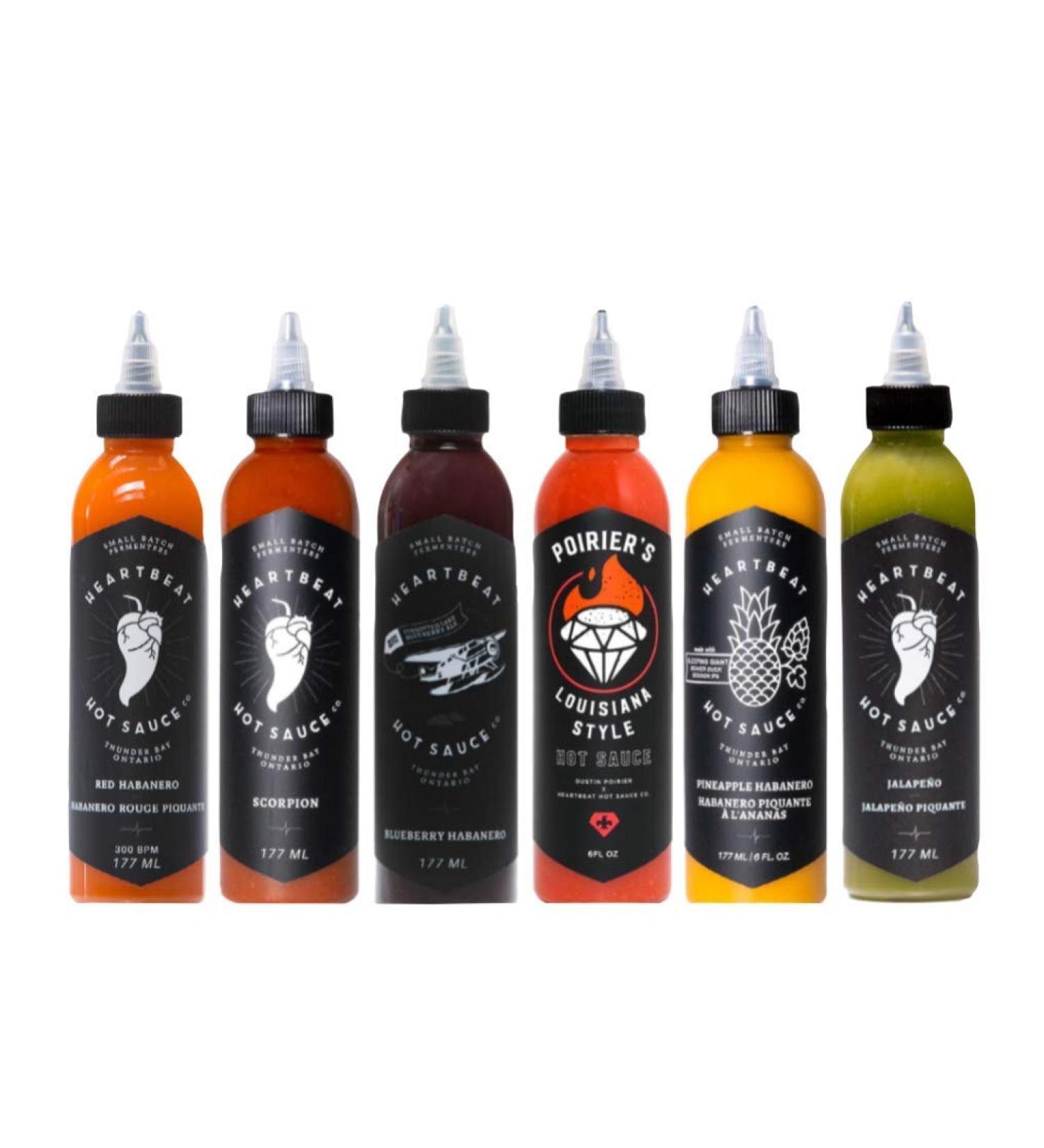 Heartbeat Hot Sauce - Ultimate 6-Pack (1 x 177ml Red Habanero 1 x 177ml Green Jalapeno 1 x 177ml Blueberry Habanero 1 x 177ml Pineapple Habanero 1 x 177ml Scorpion 1 x 177ml Poirier's Louisiana Style Hot Sauce) - Buy Online on GoSupps.com