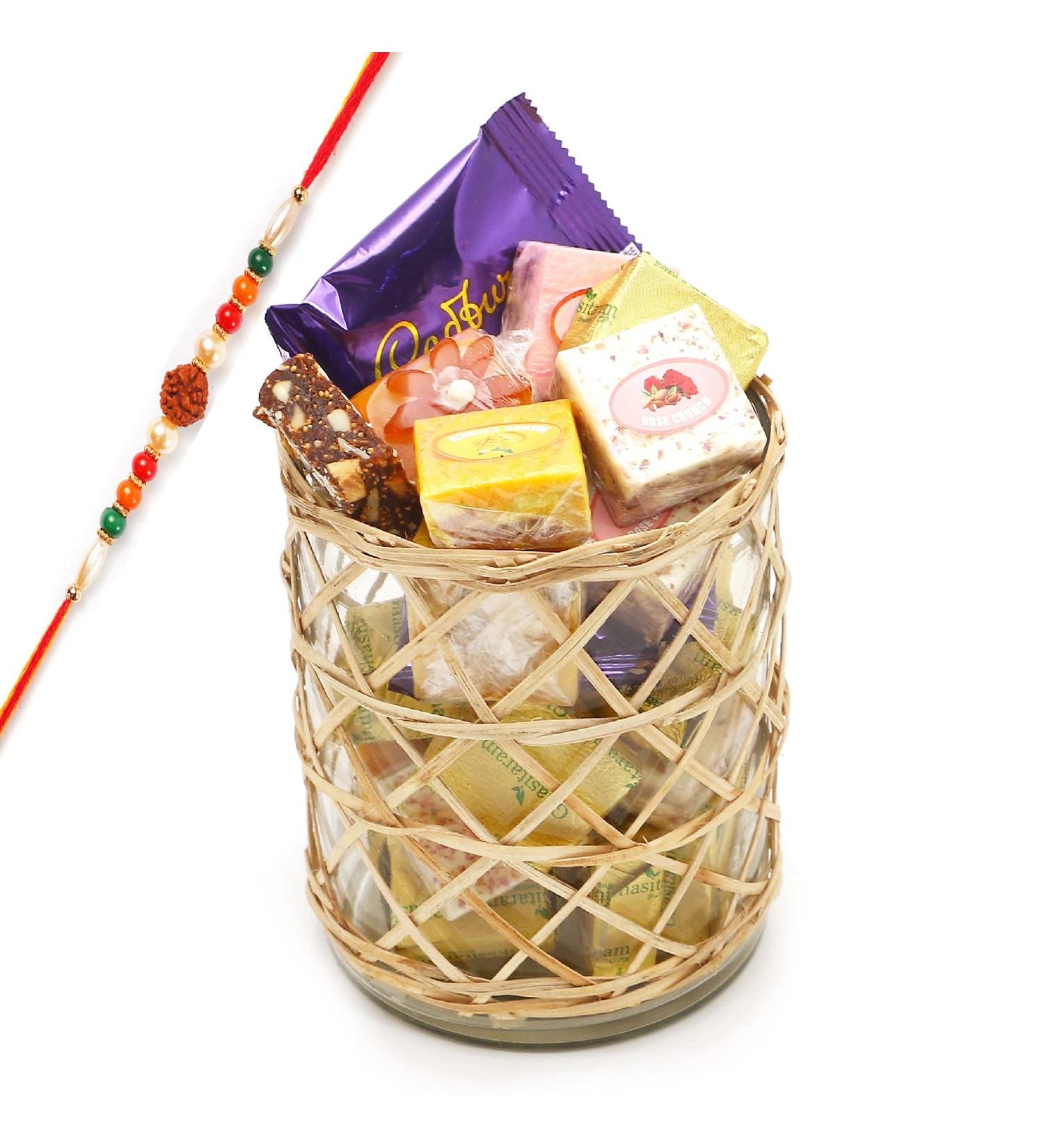 Ghasitaram Gifts Rakhi Gifts for Brothers Cane Glass Jar with Assorted Bites Laddoos and Cookies with Rudraksh Rakhi - Buy Online on GoSupps.com