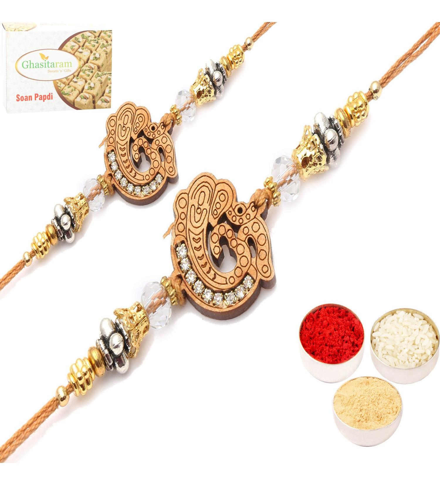 Ghasitaram Gifts Rakhi for Brother Rakhis Online - Set of 2 Om Ganeshay Diamond Ehnic Divine Rakhi with 200 GMS of Soan Papdi Set of 2 Rakhis with 200 gms of Soan Papdi - Buy Online on GoSupps.com