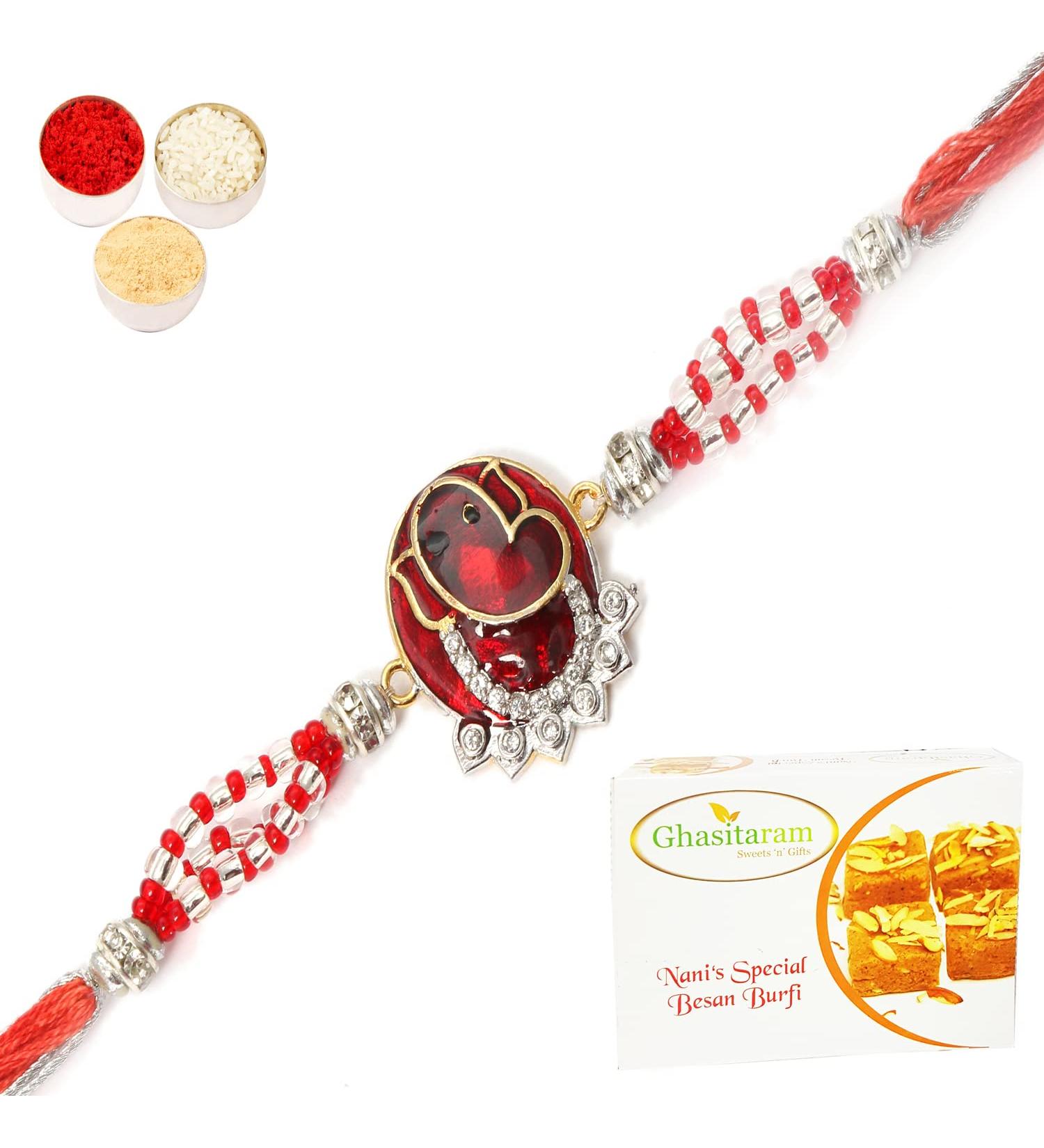 Ghasitaram Gifts Rakhi for Brother Rakhis Online - 7317 Red Sapphire Ganesha Rakhi with 200 GMS of Besan Barfi Rakhi Set with 200 gms of Besan Barfi - Buy Online on GoSupps.com