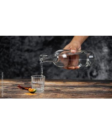 Elegant and stylized glass bottle with salt worm for mezcal from Mexico - Buy Online on GoSupps.com