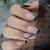Rymaup 24 pieces French tip to press the nails artificial nails complete cover artificial nails with vertebrae glitter designs shiny acrylic nails black