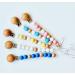 White-Sweet Jill Pacifier Clip Made with Silicone Beads and Secured with Wood Clip. 1 Piece Design. BPA-Free. Chewable. 9 Long. Keeps Pacifiers and teethers securely Fastened.