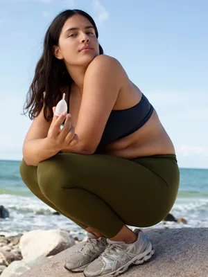 AllMatters Menstrual Cup (Formerly OrganiCup) Size A for Those Who Haven t Given Birth Vaginally. Award Winning Period Cup - Model on beach holding AllMatters menstrual cup
