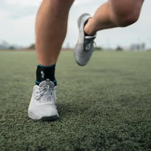 Bodyprox Ankle Support Brace Adjustable Compression Ankle Braces for Sports Protection One Size Fits Most for Men & Women 1 - Man running on grass in the BODYPROX ankle brace