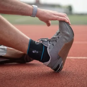 Bodyprox Ankle Support Brace Adjustable Compression Ankle Braces for Sports Protection One Size Fits Most for Men & Women 1 - Man wearing the ankle brace while stretching ankle