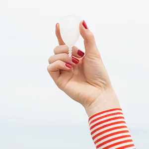 AllMatters Menstrual Cup (Formerly OrganiCup) Size Mini for Teens or Those Who Need a Smaller Size. Award Winning Period Cup - Models hand holding AllMatters menstrual cup