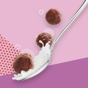 Wonderworks - Chocolate Cinnamon and Peanut Butter 10.2 Oz. - Pack of 3 - Three Wonderworks crunchy breakfast cereal puffs over a spoon with milk.