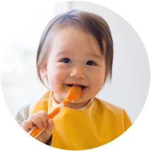 Gerber Mashed Potatoes with Meatloaf & Gravy and a side of Carrots Peas and Corn 6.67 oz. 8 Count - Happy baby eating Gerber Entrees with spoon.