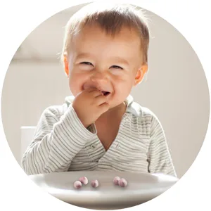 Gerber Up Age Yogurt Melts & Fruit & Veggie Melts Assorted Variety Pack 8 Count - Smiling baby eating Yogurt Melts