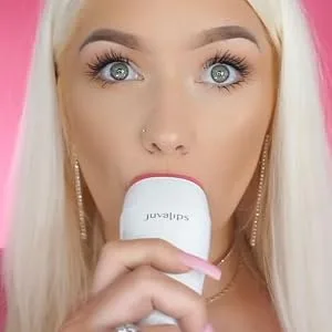 JuvaLips | Original White Lip Plumping Device & Plumping Serum | Made in the USA - Young woman holding lip plumping device up to her lips.