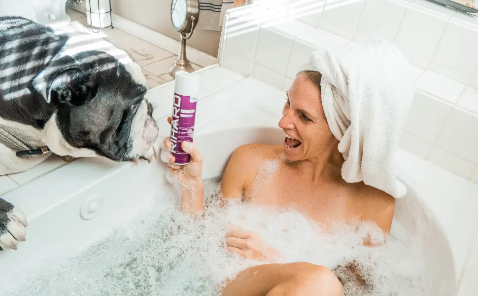 TRIHARD Swimmers Shampoo Extra Boost + Pre & Post Swim Conditioner | Chlorine And Hair Solutions | Swimming Two-In-One Duo - Ambassador relaxing near TRIHARD products.