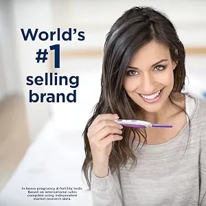 Clearblue Trying for a Baby Ovulation Kit, Featuring 25 Ovulation Tests and 2 Rapid Detection Pregnancy Tests, 27 Count 25 Ovulation Tests and 2 Pregnancy Tests - Woman smiling with clearblue stick
