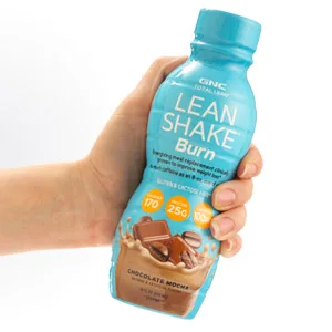 GNC Total Lean Shake + Slimvance | Caffeine Free Protein Powder, Helps Reduce Body Weight | Vanilla Carmel | 20 Servings - Lean Shake Burn product being held in hand