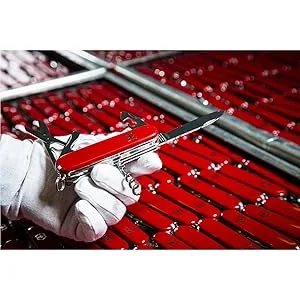 Victorinox Classic SD 7 Function Pocket Knife Red - Original Swiss Army Knife Iconic Design red on craft tool table with metal