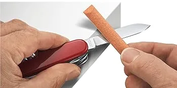 Victorinox Classic SD 7 Function Pocket Knife Red - SAK Care Tips image of how to sharpen Swiss Army Knife in red with orange stone