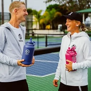Takeya Pickleball Insulated Water Bottle with Straw Lid 32 Ounce Backspin Pink Backspin Pink 32 oz Straw Lid - two people with bottles
