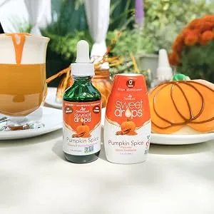 SWEETLEAF STEVIA SteviaClear Liquid Extract 4 Fl Oz (Pack of 2) - Sweet Drops Pumpkin Spice on a table with pumpkin cold coffee and pumpkin shaped cookie