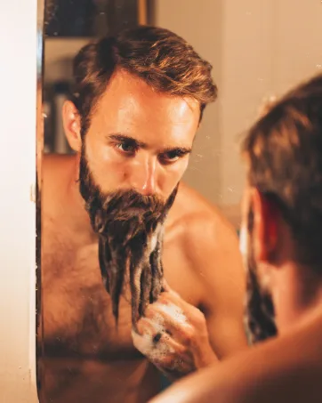 ZEUS Premium Beard Care Kit Complete Grooming Set Beard Wash Combo Beard Oil & Balm Beard Brush & Comb (Sandalwood) - man washing his beard with Zeus Beard Shampoo