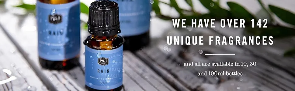 P&J Fragrance Oil - Eucalyptus Scented Candles Soaps Diffusers and More - 100ml - Dark amber bottle with bright blue label which read Rain Fragrance Oil on a white wood table.