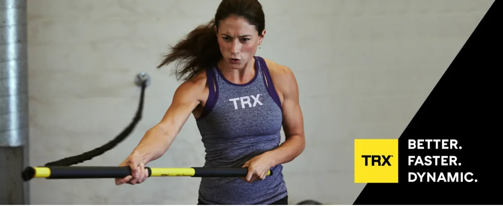 TRX Training RIP Trainer Basic Kit Weighted Workout Bar and Resistance Band Set Home Resistance Training Kit for Core-Strength Training 20 Lbs. - A woman using a TRX resistance band. Text reads: TRX. Better. Faster. Dynamic.