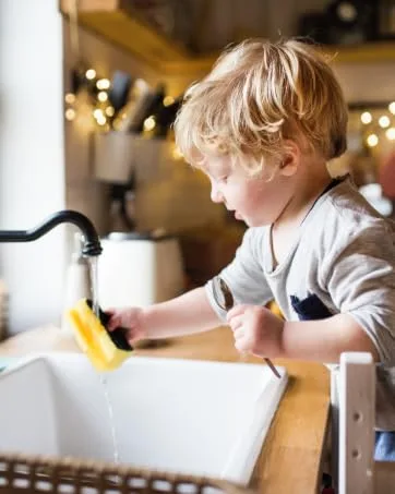 Oasis Biocompatible Laundry Detergent Liquid - Reuse Greywater for Plants - Clean Safe Concentrated & Effective Grey Water Friendly Sodium-Free Biodegrades Into Plant Nutrients - HE 128 Loads - Child washing a spoon with Oasis soap