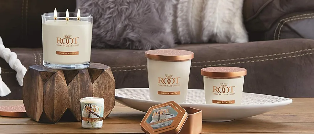 Root Candles Scented Spa Candles Seeking Balance Handcrafted Aromatherapy Candle 8-Ounce Cleanse: Lime + Galbanum - Vanilla scented candles in various sizes and containers sit on a wooden living room coffee table