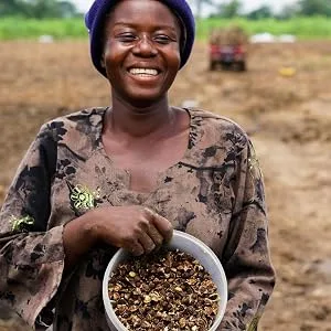 True Moringa Moringa Face Mask | Deep Pore Detox Clarifying and Purifying Facial Mask | Vegan Skincare - Woman holding moringa seeds