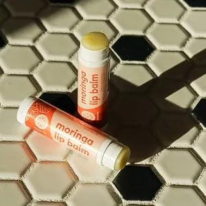 True Moringa Lip Balm - Intense Hydration & Relief for Dry Chapped Lips with Moringa and Shea Butter - 100% vegan paraben free sulfate free ethically sourced - open moringa balms next to each other