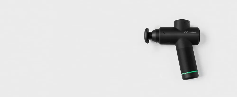 Hyperice Hypervolt Go 2 in Black - Featuring Quiet Glide Technology - Handheld Percussion Massage Gun | 3 Speeds 2 Interchangeable Heads | Helps Relieve Sore Muscles and Stiffness | FSA-HSA Eligible Hypervolt Go 2 Black - Hypervolt Go 2 laying flat on a white tabletop