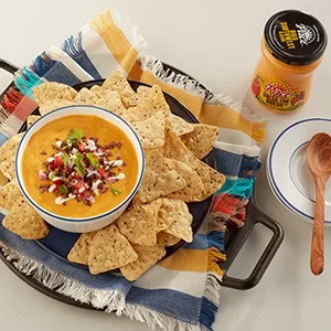 Pace Mild Picante Sauce, 64 Ounce Fish - Place setting with jar of queso dip and a bowl of queso dip upon a plate of tortilla chips