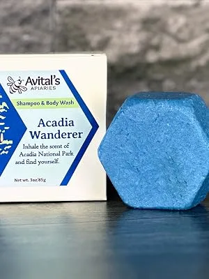 Avital's Apiaries Redwoods Shampoo & Body Wash Bar with panthenol and quinoa protein - A blue hexagonal bar next to a box labeled Acadia Wanderer
