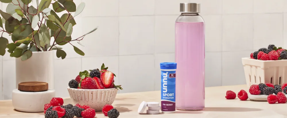 Nuun Hydration Electrolyte Tablets - Dissolvable in Water Complete Pack | 5 Essential Electrolytes for Hydration | 1g Sugar Drink Mix | Vegan Non-GMO | 4 Pack (40 Total Servings) - nuun sport tri-berry on a countertop with berries