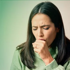 Amazon Basic Care Mucus DM Guaifenesin and Dextromethorphan Hydrobromide Extended-Release Tablets, 600 mg/30 mg, Expectorant and Cough Suppressant, 40 Count - woman coughing