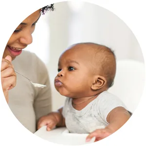 Gerber Lil Bits Whole Wheat Apple Blueberry Baby Cereal, 8 Oz , Pack of 6 - Mom spoon-feeding baby infant cereal