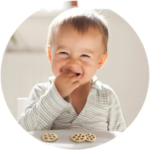 Gerber Snacks for Baby Teether Wheels, Apple Harvest, 1.48 Ounce (Pack of 6) - Smiling baby eating Teether Wheels