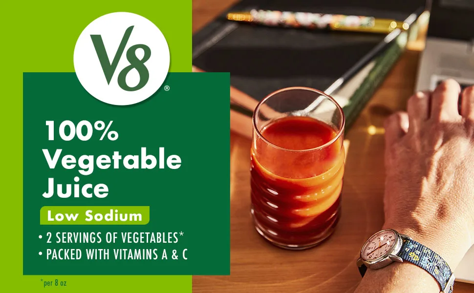 V8 Low Sodium Original 100% Vegetable Juice, 5.5 oz. can (4 packs of 6, total of 24) - Text and logo V8 100% Vegetable Juice Low Sodium pictured with glass of juice and hand at desk
