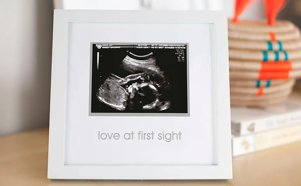 Pearhead Love at First Sight Sonogram Picture Frame, Pregnancy Keepsake Photo Frame, Gender-Neutral Baby Nursery Dcor, Mothers Day Accessory, White Love at First Sight Frame, White - White wooden baby frame sitting on table as cute home decor