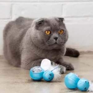 Petstages Kitty Slow Feeder Cat Bowl, Blue - cat playing with Petstages Firefly Treat Stuffer Glow-in-The-Dark Cat Toy