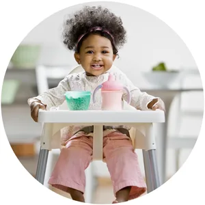 Gerber Juice, White Grape, 32 oz - Toddler in high chair with juice cup.