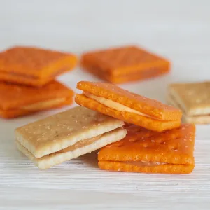 Austin Sandwich Crackers, Single Serve Snack Crackers, Office and Kids Snacks, Peanut Butter on Cheese, 11oz Tray (8 Packs) - Square cheddar cheese sandwich snack crackers with salt and tasty filling displayed on a white table