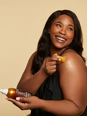 COOLA Sunless Self Tanner Kabuki Body Brush, Self Tan Applicator for Organic Sunless Tanning Lotion - model applying sunless tan serum with coola kabuki body brush