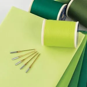 Superior Threads - Titanium-Coated Topstitch Needles #90/14 - for Quilting, Embroidery, and Sewing, 5 Count - Superior Threads Topstitch needles displayed with fabric and thread