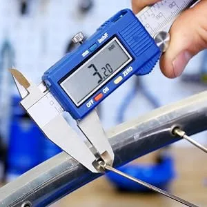 Park Tool Triple Spoke Wrench 1 - Vernier calipers measuring the wrench flats of a bicycle wheel spoke nipple