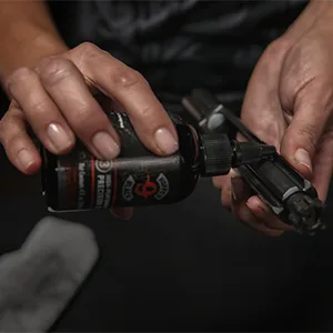 Hoppe's HBL4 black Precision Gun Oil Liquid, 4 oz - hands