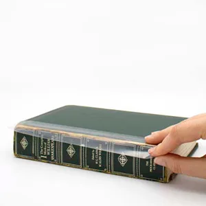 BookGuard 2 inch Premium Bookbinding Repair Cloth Tape, 15 Yard Roll, Black - Hand applying clear poly BookGuard tape to old book spine