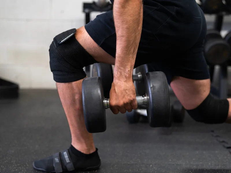 Bodyprox Knee Wrap 2 Pack for Squats, Weightlifting, Powerlifting, Leg Press, and Cross Training, Knee Support for Men and Women - Man lunging in the gym