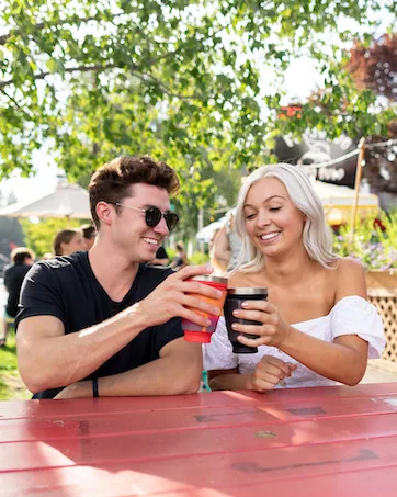 HYDAWAY Collapsible Bowl | Portable, Packable Dish for Camping, Hiking, Backpacking, Campervans, Travel, Kids and Pets | 1-Quart Capacity (Jet Black) - A couple drinking cocktails using HYDAWAY Collapsible Drink Tumblers