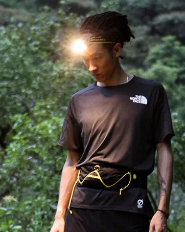 Nitecore NWS10 TC4 Titanium Outdoor Emergency Whistle 120 Decibeles (NWS10 Emergency Whistle) - trail runner with his headlamp turned on
